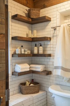 a white toilet sitting next to a bath tub under a bathroom shelf filled with towels