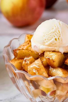 an apple dessert with ice cream in a glass bowl