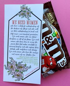 a candy bar with a note on it sitting next to a bag of candies