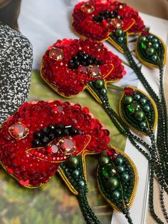 red and green beaded flowers are on display