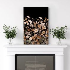 a white fireplace with flowers on the mantle