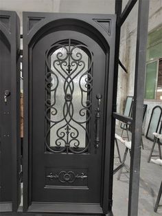 an ornate iron door with glass panels