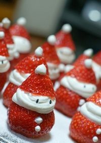 some strawberries with santa hats on them