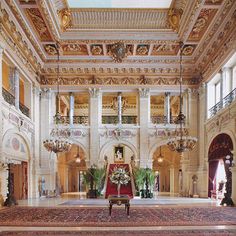 an ornately decorated room with chandeliers and rugs