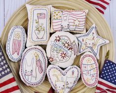 some patriotic cookies are on a plate with american flags