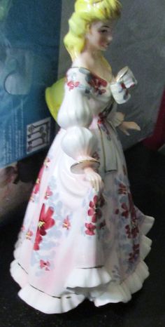 a ceramic figurine of a woman in a dress