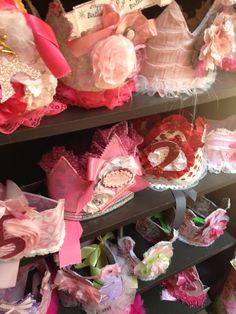 many different types of bras are on display in a store window with ribbons and bows