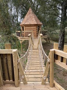 there is a wooden bridge that leads to a tree house