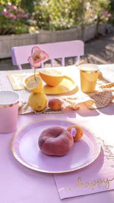 there is a plate with some fruit on it and two cups next to the plate