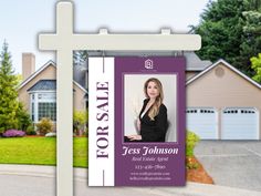 a real estate for sale sign in front of a house with a cross on it