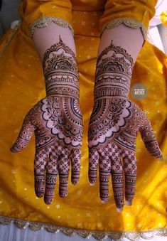 two hands with henna designs on them