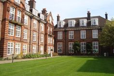 a large building with lots of windows and green grass