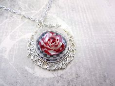 "Alice in Wonderland Necklace - Red Queen Painting the Roses Red Necklace - Wonderland Jewelry Queen of Hearts Glass Dome Halloween Jewelry For the true Alice in Wonderland fan! I absolutely love this necklace! It's a real show stopper and a certain conversation piece. Just as the Red Queen dictated, I've painted a white rose red (a sparkly red!) and encased it inside of a clear dome. The rose sits securely on a black and white checkerboard on top of an ornate black or shiny silver pendant. I th Queen Of Hearts Jewelry, Alice In Wonderland Jewelry, Queen Painting, Jewelry Queen, Wonderland Jewelry, Painting The Roses Red, Alice's Adventures In Wonderland, Roses Red, Red Necklace