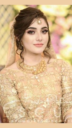 a woman in a bridal outfit posing for the camera