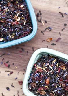 two blue bowls filled with different types of tea