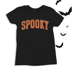 Spooky graphic in a varsity orange and white font. Perfect for this spooky season! Wear to school dress up days, Halloween parties, or just around town for halloween spirit! For All Varsity Spooky T-shirts click here to view.For Adult & Youth Varsity Spooky Sweatshirts click here to view. Adult Sizes S-XXL (unisex sizing)Youth Sizes S-XL (unisex sizing)Toddler Sizes 2T, 3T, 4T (unisex sizing) Bella + Canvas (Adult, Youth & Toddler)4.2 oz. Airlume combed and ring-spun cottonPre-shrunkFor a more relaxed fit, size up! Spooky Halloween Fan Merchandise T-shirt, Spooky Letter Print T-shirt For Costume Party, School Spirit T-shirt For Fall Season, Halloween Costume Party T-shirt With Letter Print, Black Collegiate T-shirt For Fall, Halloween Costume Party Letter Print T-shirt, Halloween Letter Print T-shirt For Costume Party, Black Fall School T-shirt, Black T-shirt For School In Fall