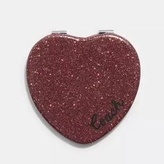 New!! Coach Glitter Heart Compact Mirror ~ Gold Wine Sparkly Heart Accessory New! In Original Packaging! Color - Gold Wine Glitter With Black Coach Cursive Signature (Red Color) Materials - Man-Made Leather, Metal And Glass Size -2 1/2" (L) X 2 1/4" (H) Style No. Cf153 One Mirror Is Regular For A Quick Makeup Check. The Other Has A Little Bit Of Magnification! The Foldable Pocket Mirror Fits Easily In Even Smaller Purses, So You Can Take It Anywhere. It Makes A Perfect Gift Or Stocking Stuffer!! Cursive Signature, Heart Shaped Mirror, Gold Wine, Heart Mirror, Shaped Mirror, Heart Accessories, Quick Makeup, Mirror Gold, Glitter Hearts