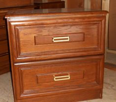 a wooden dresser with two drawers on top of it