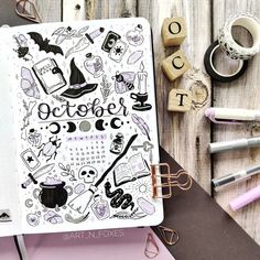 an open notebook with the words october written on it and various other items surrounding it