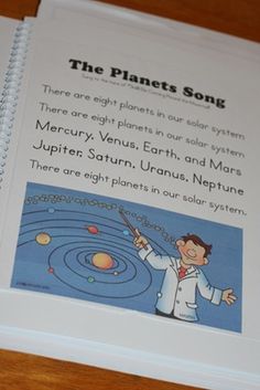 the planets song book is open on a table