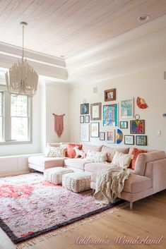 a living room filled with lots of furniture and pictures on the wall above it's couch