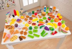 a white table topped with lots of different types of food and condiments on top of it