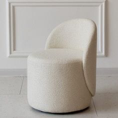 a white chair sitting on top of a hard wood floor