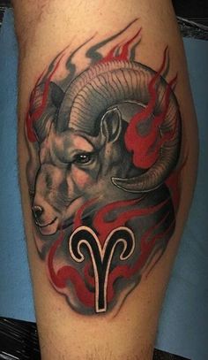 a ram tattoo on the leg with red flames