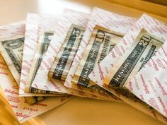 a pile of twenty dollar bills sitting on top of each other next to a drawer