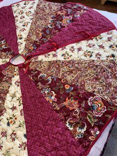 a quilted table cloth with red and white designs