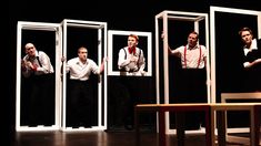 five men in white shirts and ties standing on stage