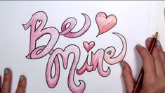 someone is drawing the words be mine on paper