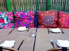 the table is set with place settings for two people to sit down and enjoy their meal