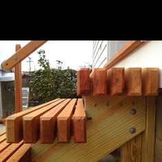 a wooden bench sitting next to a building