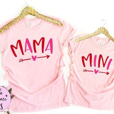 two pink shirts with the word mama and an arrow on them, sitting next to each other