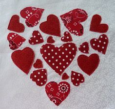 red and white heart shaped appliques are arranged in the shape of hearts