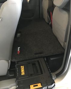 the back seat of a car with its cargo compartment open and tools in the trunk