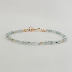 Elevate your style with this dainty aquamarine pale blue crystal bracelet. Adorned with minimalist gemstone beads, this beaded bracelet is a perfect March birthstone accessory. This exquisite piece doubles as a sentimental 19th-anniversary gift for women, making it a thoughtful and stylish Mom gift idea. * Genuine blue aquamarine gemstone beads * March Birthstone * 19th wedding anniversary gift * 2mm - 2.5mm faceted gemstone beads * 14k gold fill or sterling silver  * Chain and findings are nick Adjustable Aquamarine Beaded Bracelets, Dainty Blue Faceted Beaded Bracelets, Elegant Light Blue Aquamarine Bracelet, Elegant Adjustable Light Blue Crystal Bracelet, Beaded Bracelets Pearl, Elegant Light Blue Adjustable Crystal Bracelet, Dainty Faceted Beaded Bracelets For Everyday Wear, Light Blue Aquamarine Beaded Bracelets For Gift, Light Blue Aquamarine Beaded Bracelets As Gift