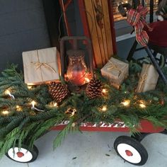 a wagon filled with christmas presents sitting on top of a porch