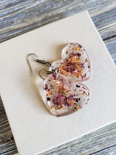 Beautiful natural rose petals in heart resin earrings. Hues of amber red paired with fiery copper flakes make these natural earrings boldly colorful. Bronze metal earrings with handmade resin heart pendants with real dried rose petals ♥ Be sure to check out the ORANGE EARRINGS section at EarringsbyLCreations for all beautiful orange colored earrings available! https://www.etsy.com/shop/EarringsByLCreations?section_id=28420987 Made with quality materials and always nickel and lead free metals. Na Handmade Heart-shaped Flower Earrings For Gift, Heart-shaped Flower Earrings For Mother's Day Gift, Resin Heart Earrings For Gifts, Pink Resin Heart Earrings As Gift, Pink Resin Heart Earrings For Gift, Valentine's Day Heart-shaped Flower Earrings For Pierced Ears, Handmade Heart-shaped Resin Earrings, Heart Shaped Resin Jewelry For Valentine's Day, Heart-shaped Resin Jewelry For Valentine's Day