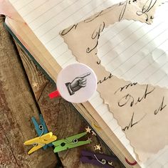 an open book with scissors and writing on it