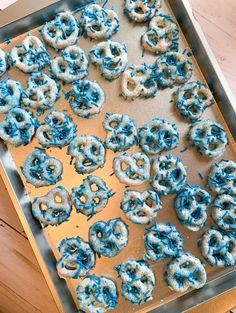 blue and white doughnuts are on a baking sheet