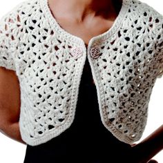 a woman wearing a white crochet shrugr