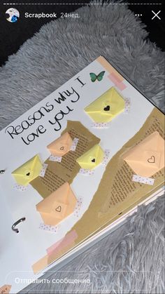 an open book with paper birds on it and the words reason may i love you