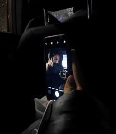 a person taking a photo with their cell phone in the dark