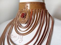 Unleash your bohemian soul with this beautiful one off unique large handmade leather choker necklace with red jasper gemstone. Red Jasper is a stone of empowerment. This necklace is made from the finest quality leather which is hand punched with a tribal design. This is not only a necklace it is a piece of art. Approximate Dimensions: Length 23cm Width 21cm This large leather choker necklace is adjustable at the back so it fits all sizes. Available in a wide range of colors. The product is new a Adjustable Artisan Choker, Elegant Brown Choker For Festival, Handmade Leather Choker Necklace, Leather Choker Jewelry As A Gift, Handmade Rust Leather Jewelry, Unique Brown Choker For Festival, Unique Brown Festival Choker, Elegant Leather Jewelry For Festivals, Handmade Leather Necklaces For Festivals