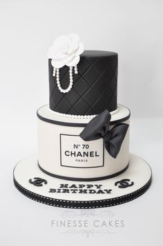 a black and white chanel cake with pearls on top