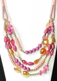 Pink multi strand four row necklace has a mix of genuine glass, stone and acrylic beads on a pink satin cord.  Necklace has    various shades of pink, tangerine, and  gold tone beads and stones.  Graduated overall length is 22".  Necklace has a lobster  claw clasp for closure with a 3" gold tone chain extension.  Gorgeous necklace for Society, and Pink - Red Hat ladies.   Excellent quality. Item #318P Pink Adjustable Beaded Necklaces For Costume Jewelry, Adjustable Multi-strand Pink Jewelry, Pink Multi-strand Beads For Jewelry Making, Pink Multi-strand Faceted Beads Jewelry, Pink Multi-strand Jewelry With Faceted Beads, Pink Adjustable Multi-strand Necklace, Bohemian Pink Multi-strand Beads, Pink Double Strand Faceted Bead Necklace, Pink Multi-strand Faceted Bead Necklace