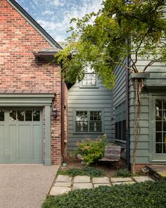 a brick house with two garages on each side