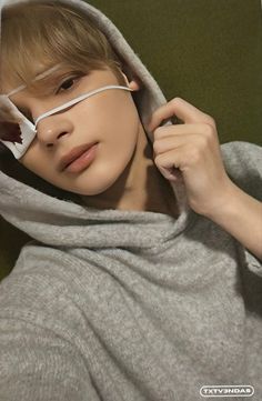 a boy in grey hoodie with glasses on his face